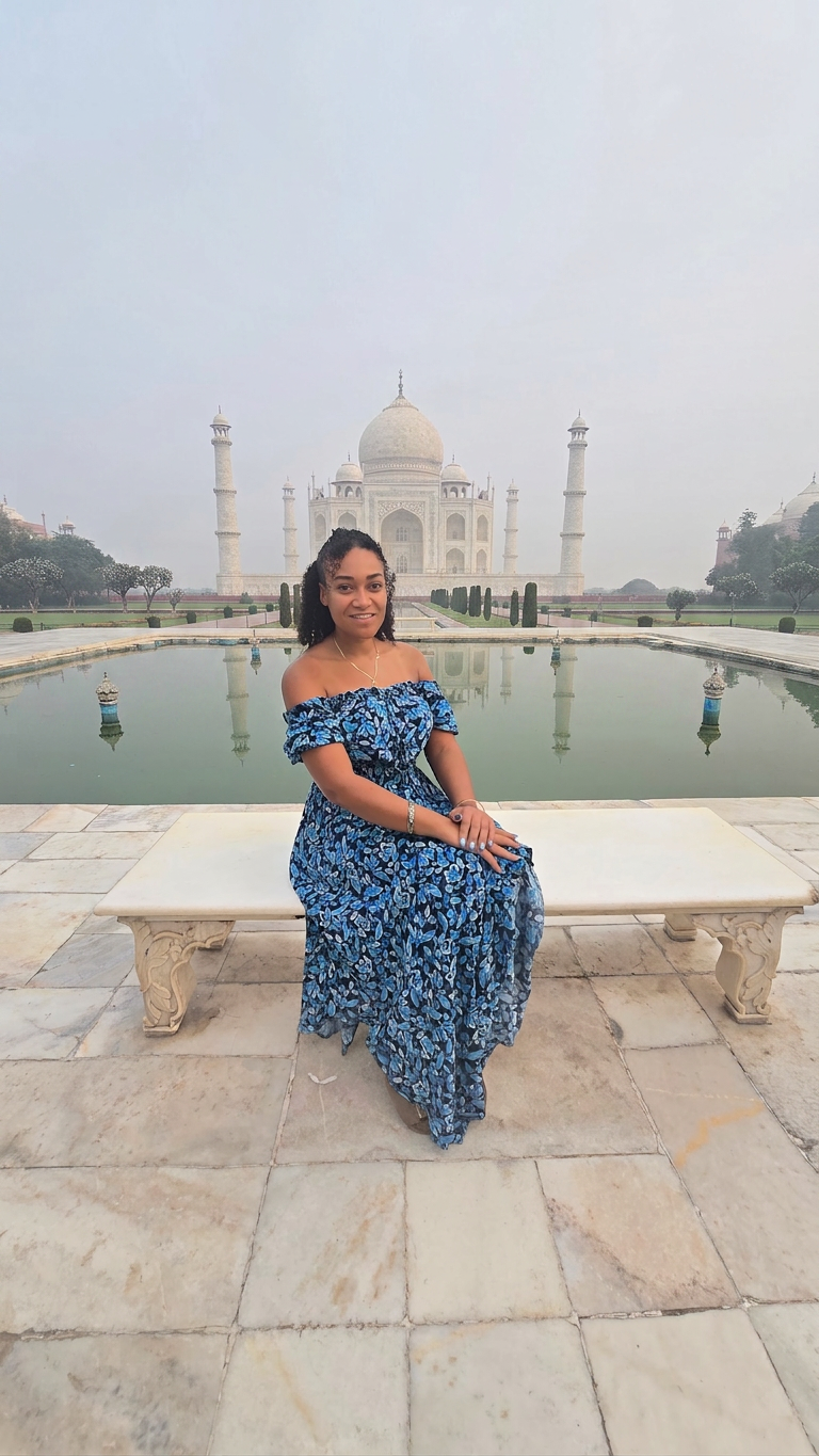 Sharmaine sitting on a bench in front of the Taj Mahal